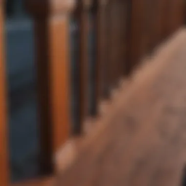 Close-up of hand staining wooden deck railing with rich mahogany paint