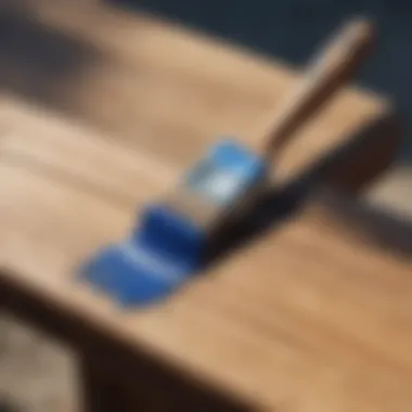 Brush strokes of vibrant blue paint on outdoor wooden bench