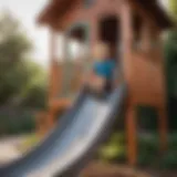 Child sliding down a vibrant playhouse slide